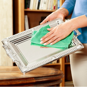 woman cleaning small mirror